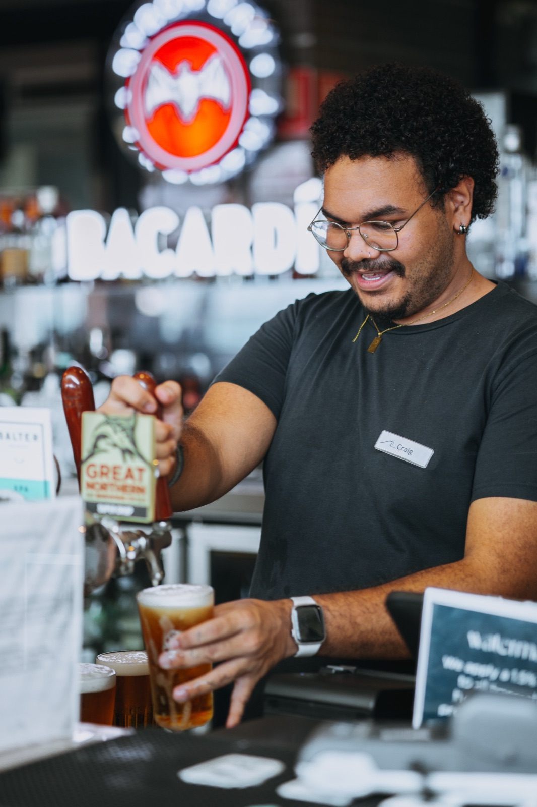 A bar owner pouring a beer, photographed during a brand content session